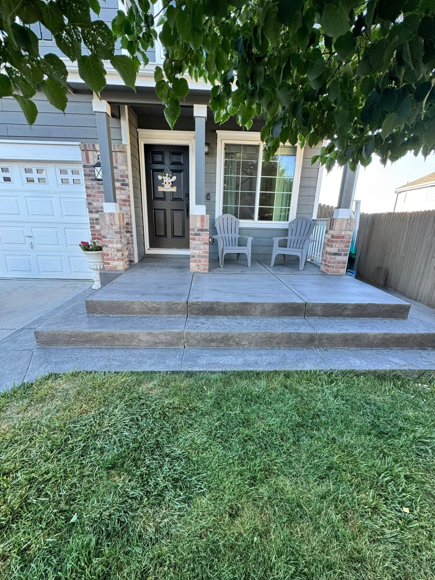 Grey stamped concrete porch with two steps and clean edges